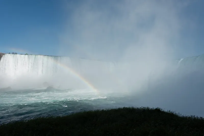 a large waterfall with a rainbow in the middle of it